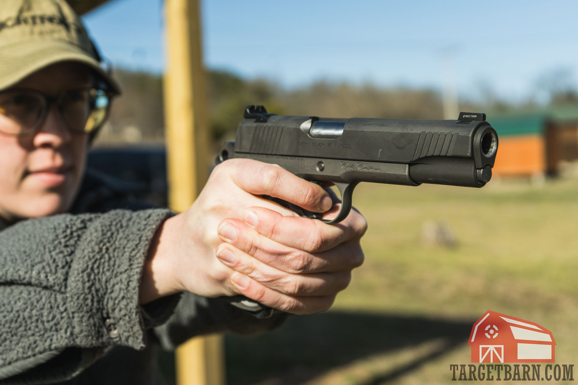 the author shooting a 1911 at the range