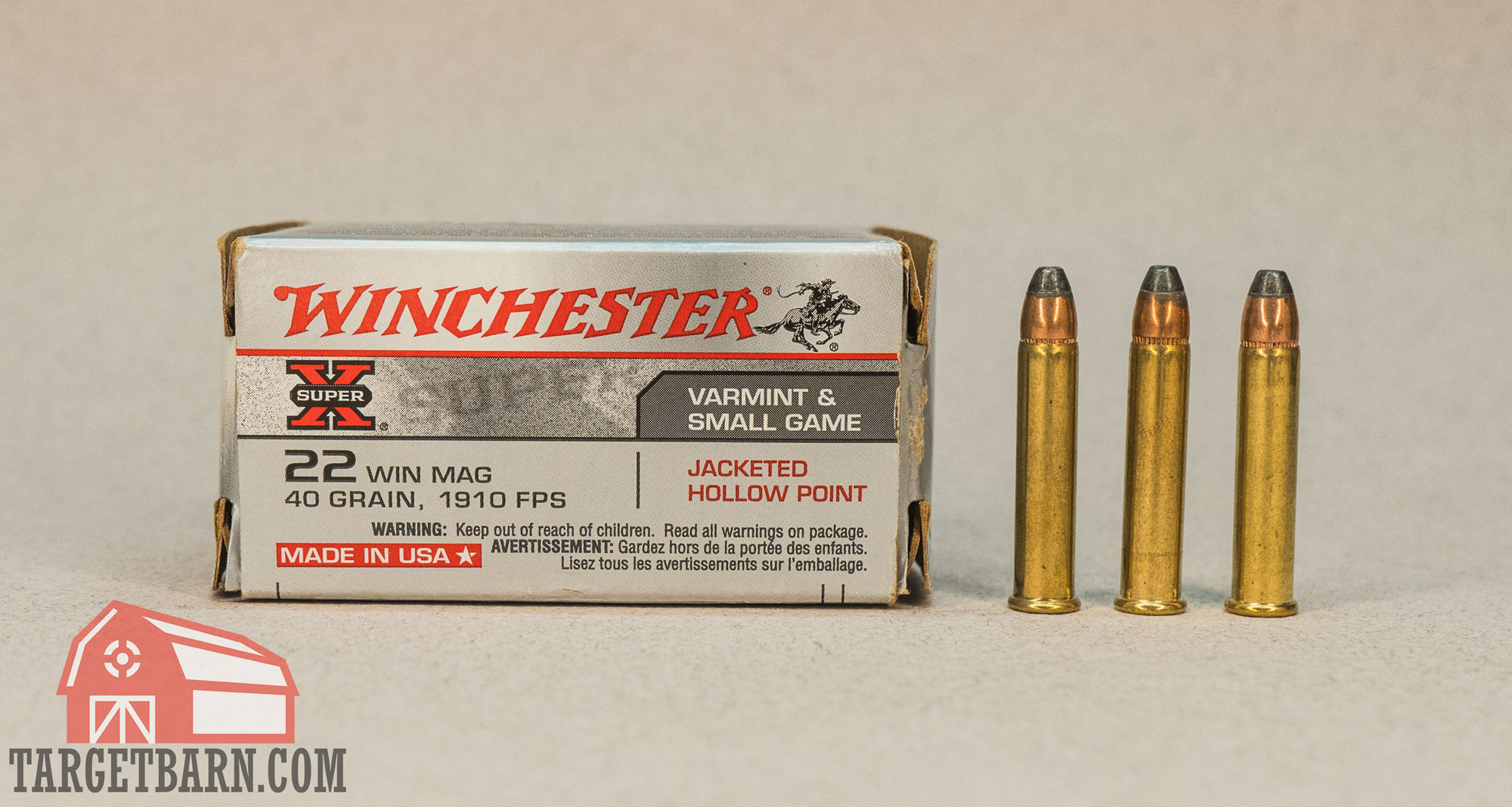 a box and three rounds of winchester 22 wmr ammo