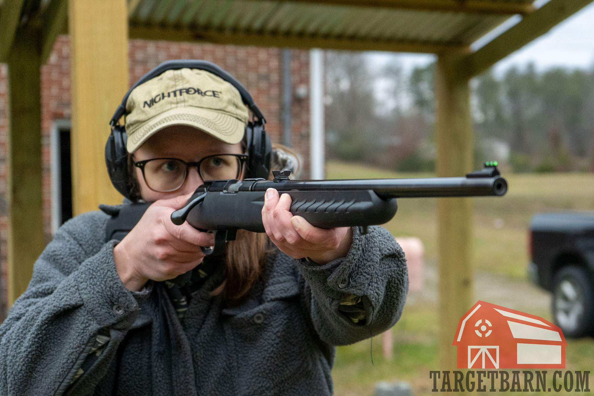 a woman shooting a 22 wmr rifle to test the .22 wmr ballistics