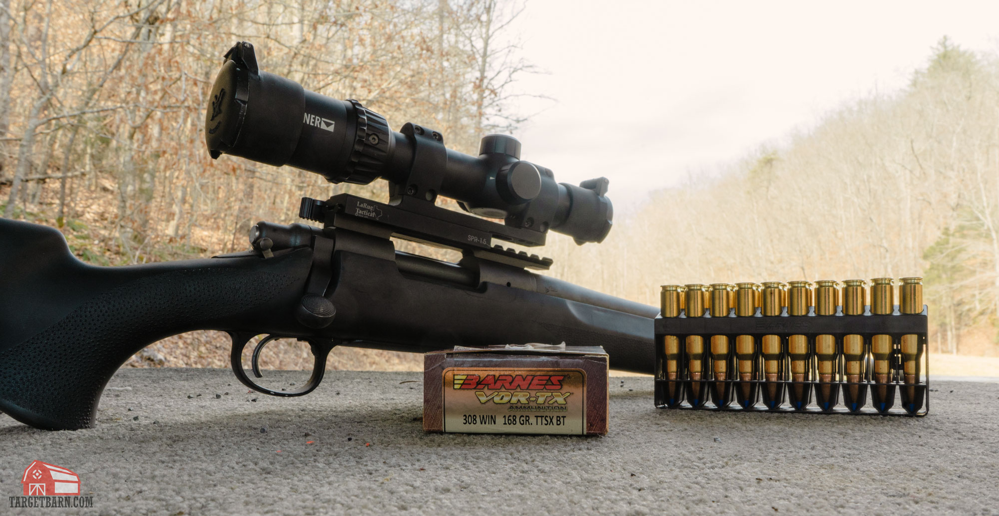 a scoped rifle and barnes vortex 308 boat tail bullets box and ammo on the shooting bench at the range