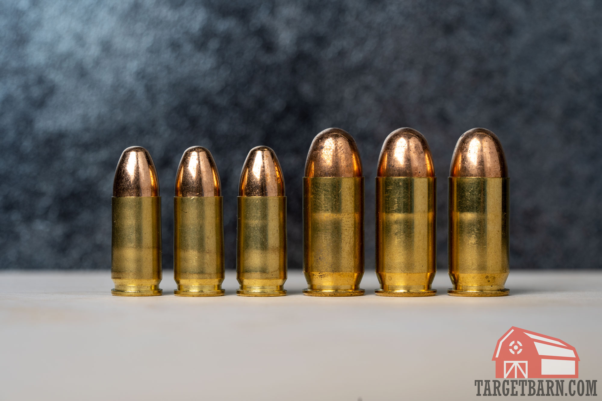 three rounds of 9mm next to three rounds of .45 acp