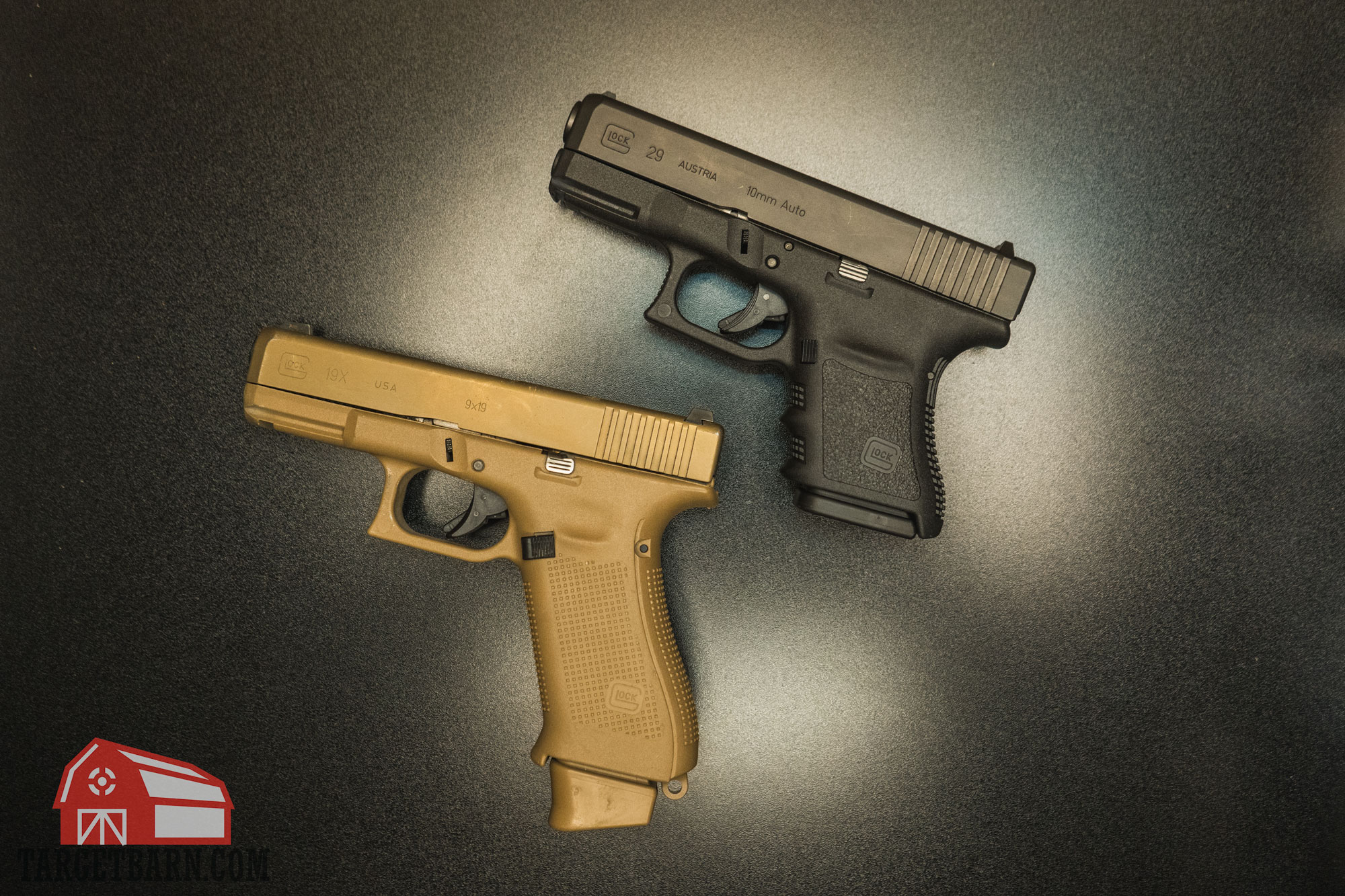 comparing 10mm vs. 9mm pistols with the glock 19x and glock 29 laying next to each other