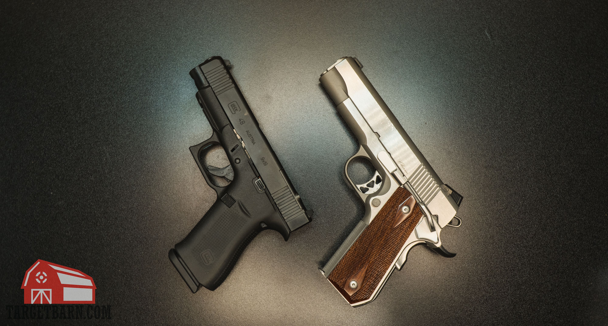 a 9mm glock 48 pistol next to a .45 ACP dan wesson commander classic pistol