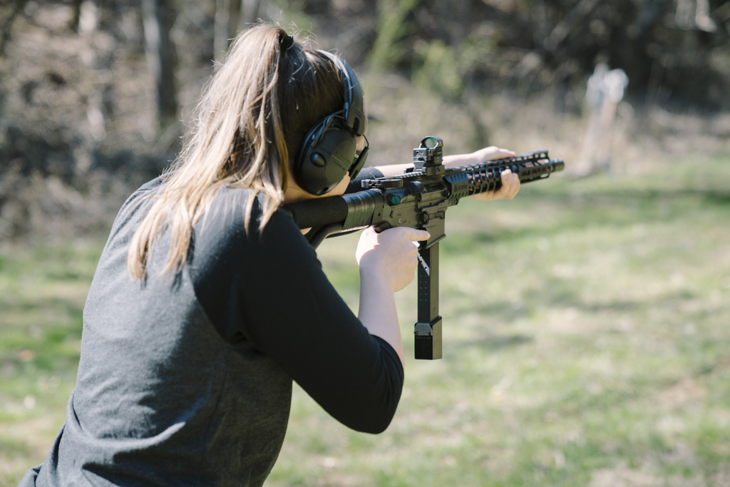 the author shooting a 9mm pistol caliber carbine at the range