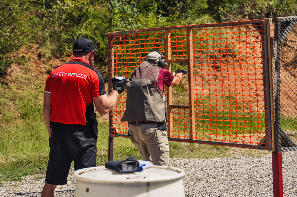 an idpa range officer watching a shooter