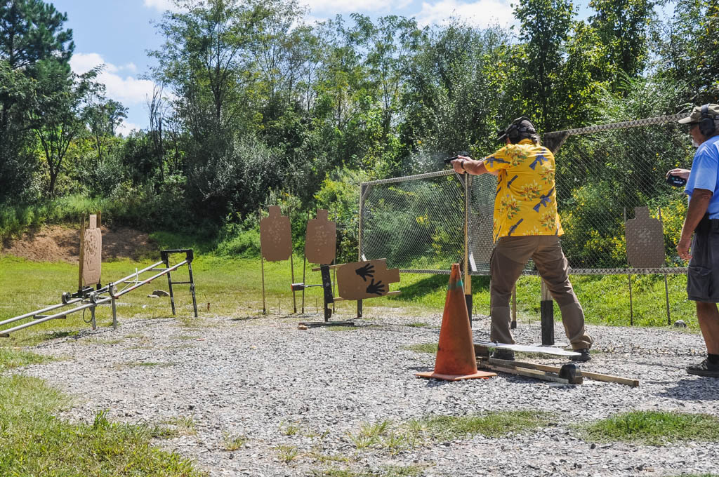 IDPA scoring in action as a shooter neutralizes a moving target