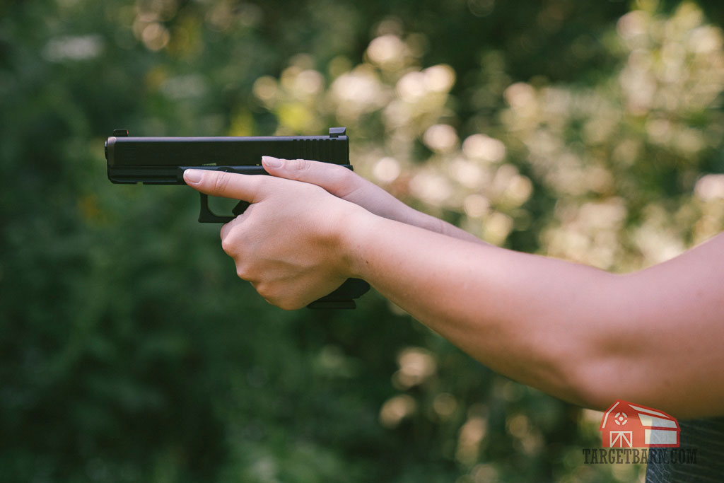 demonstrating how to grip a pistol through maximum surface contact and placement of support hand