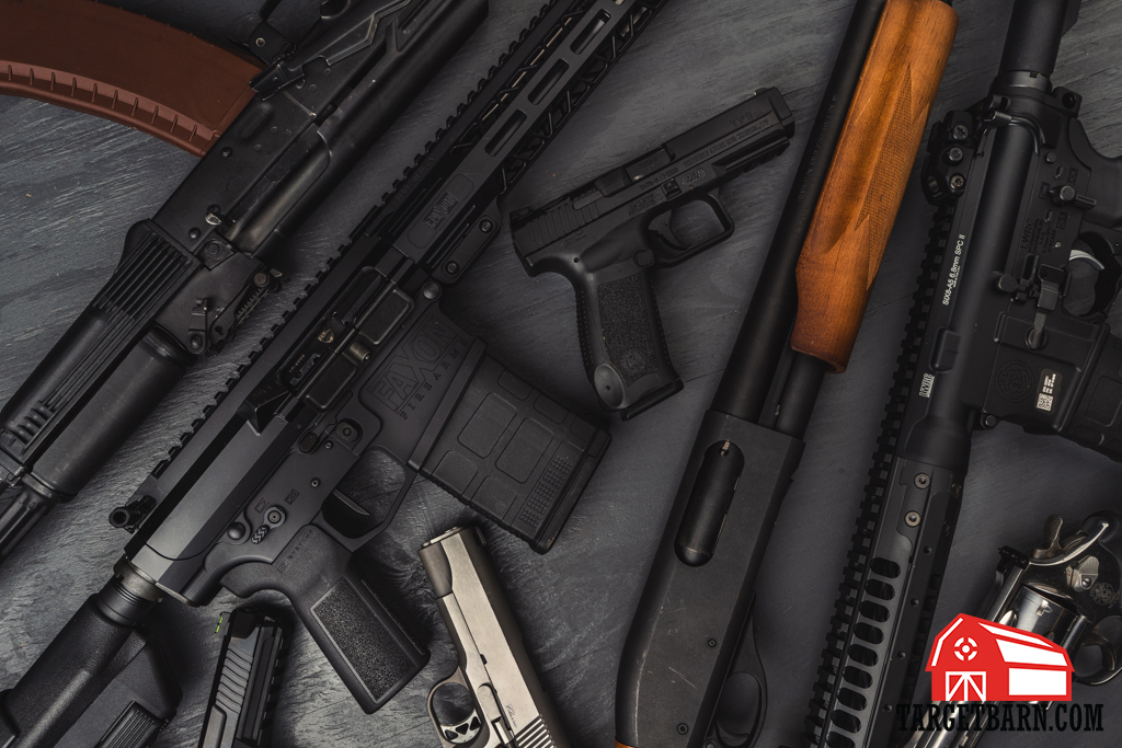 Firearms on a table Firearms laid out on a table