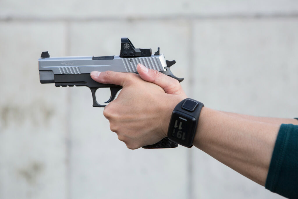 Demonstrating the proper pistol grip to help manage recoil