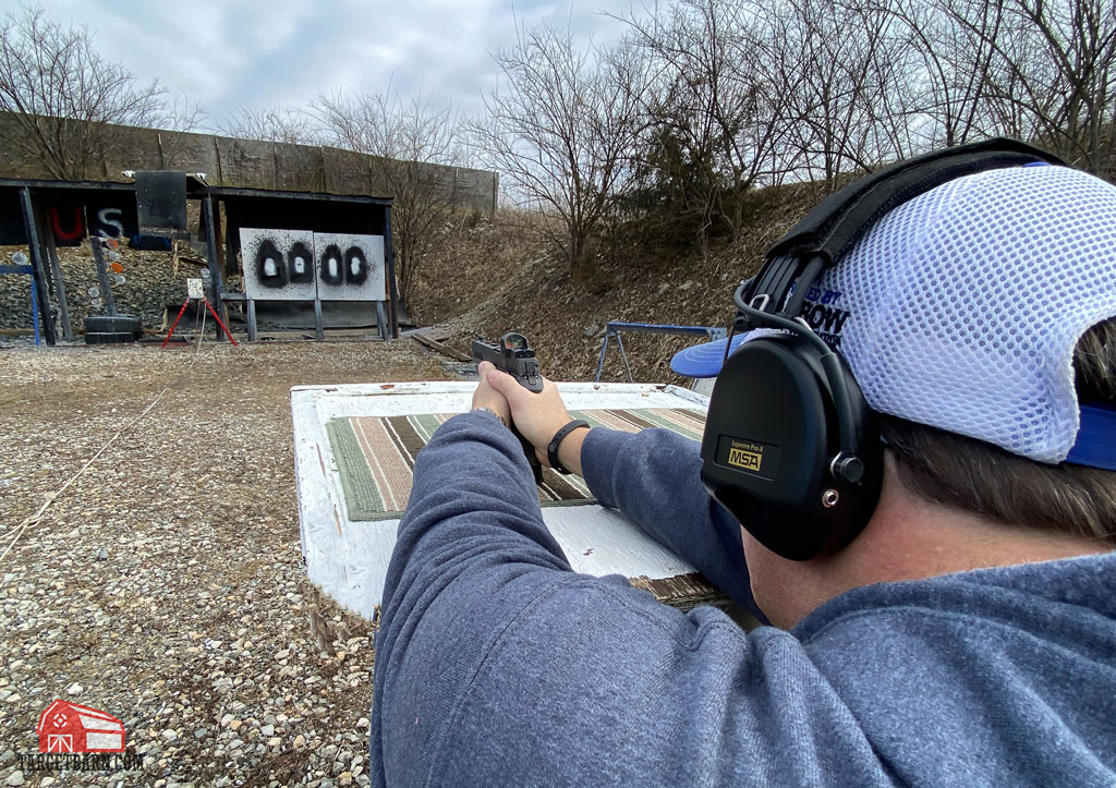 the author showing how to sight in a red dot optic using a supported mechanical process