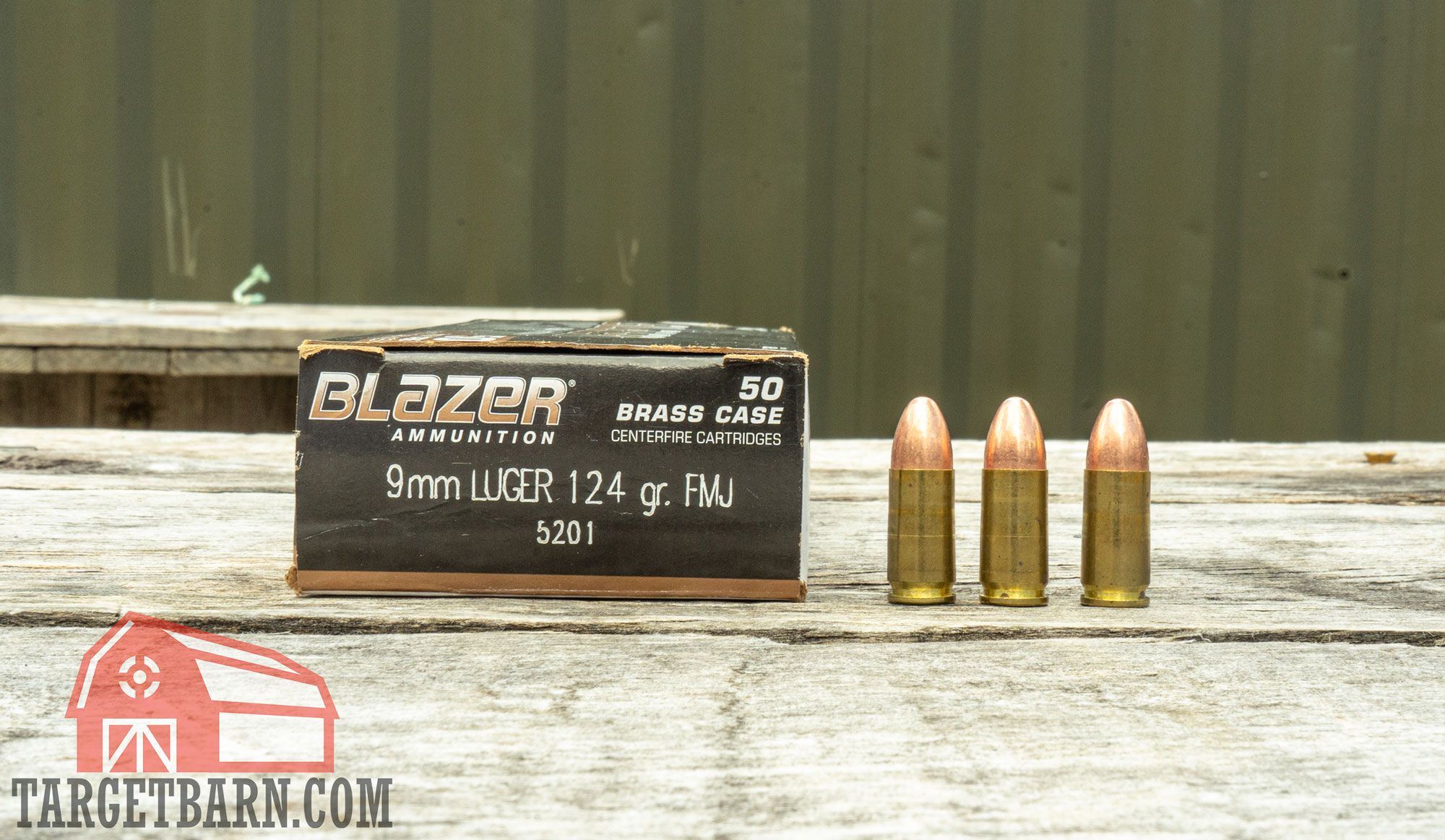 a box and three rounds of cci blazer brass 9mm 124 gr ammo