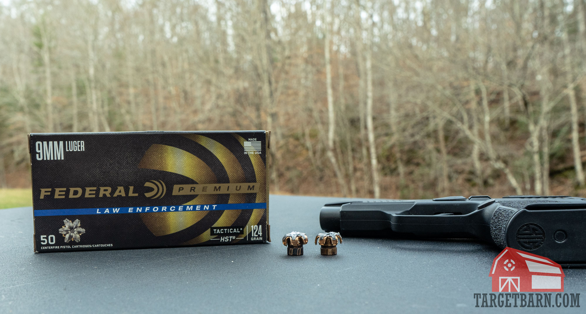 a box and two rounds of expanded federal le 9mm 124gr hst
