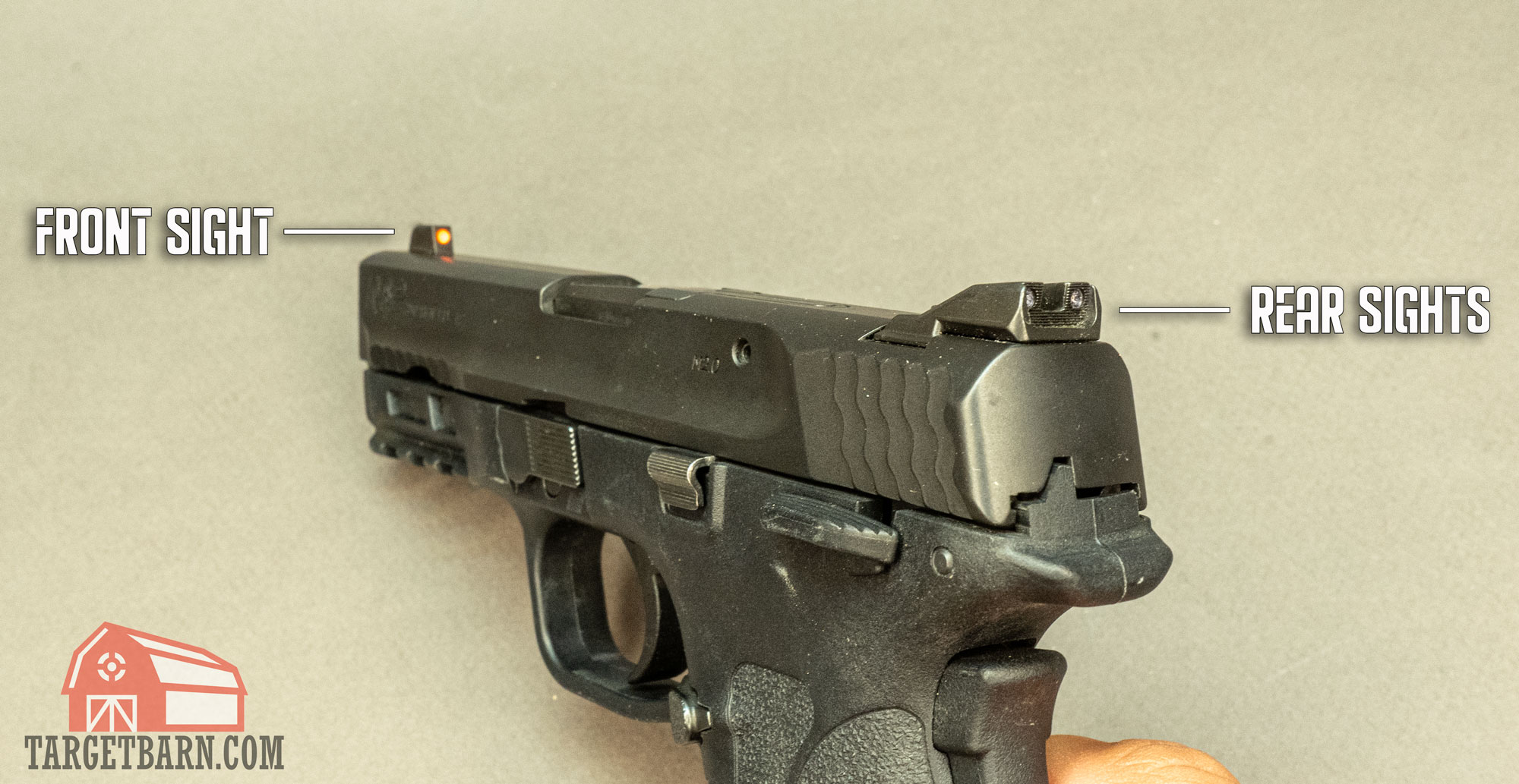 showing the front sight and rear sights on a pistol to show how to aim with iron sights