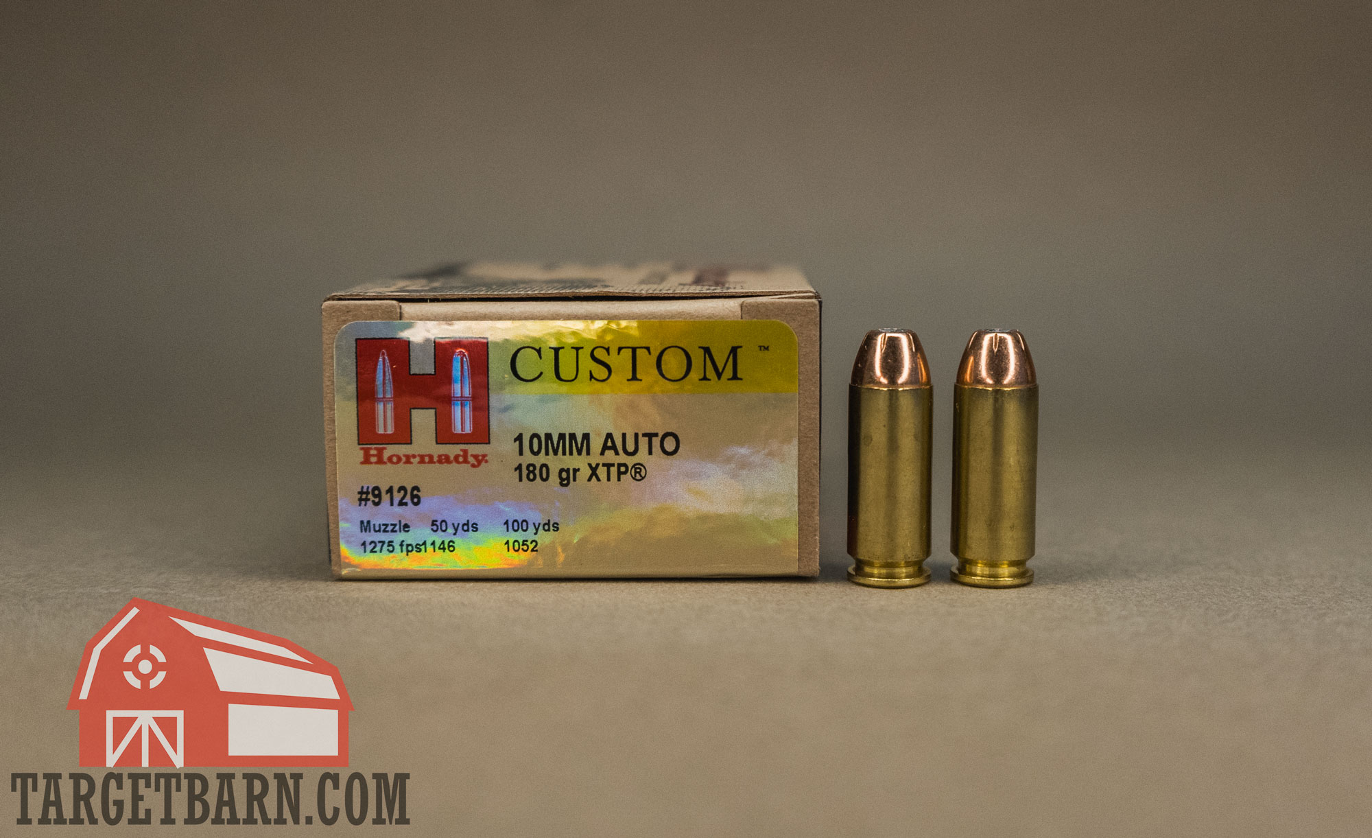 a box and two rounds of hornady custom 10mm ammo