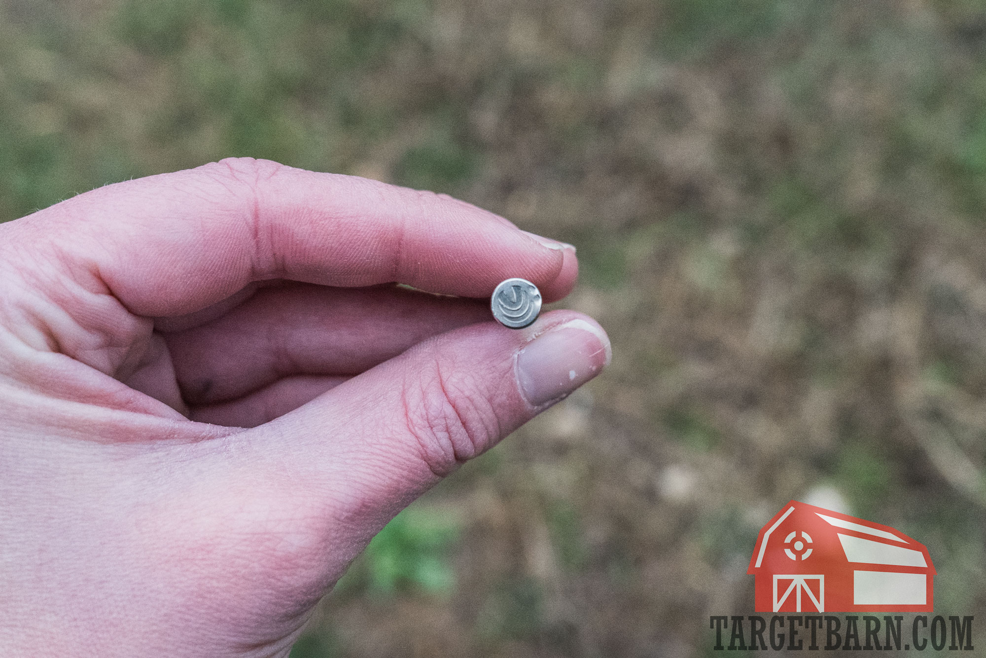 holding a .22 wmr round showing two light primer strikes