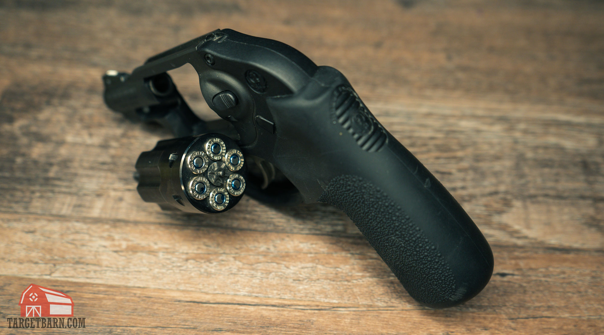 a snub nose revolver chambered in .327 federal magnum with an open cylinder that is loaded with ammo 
