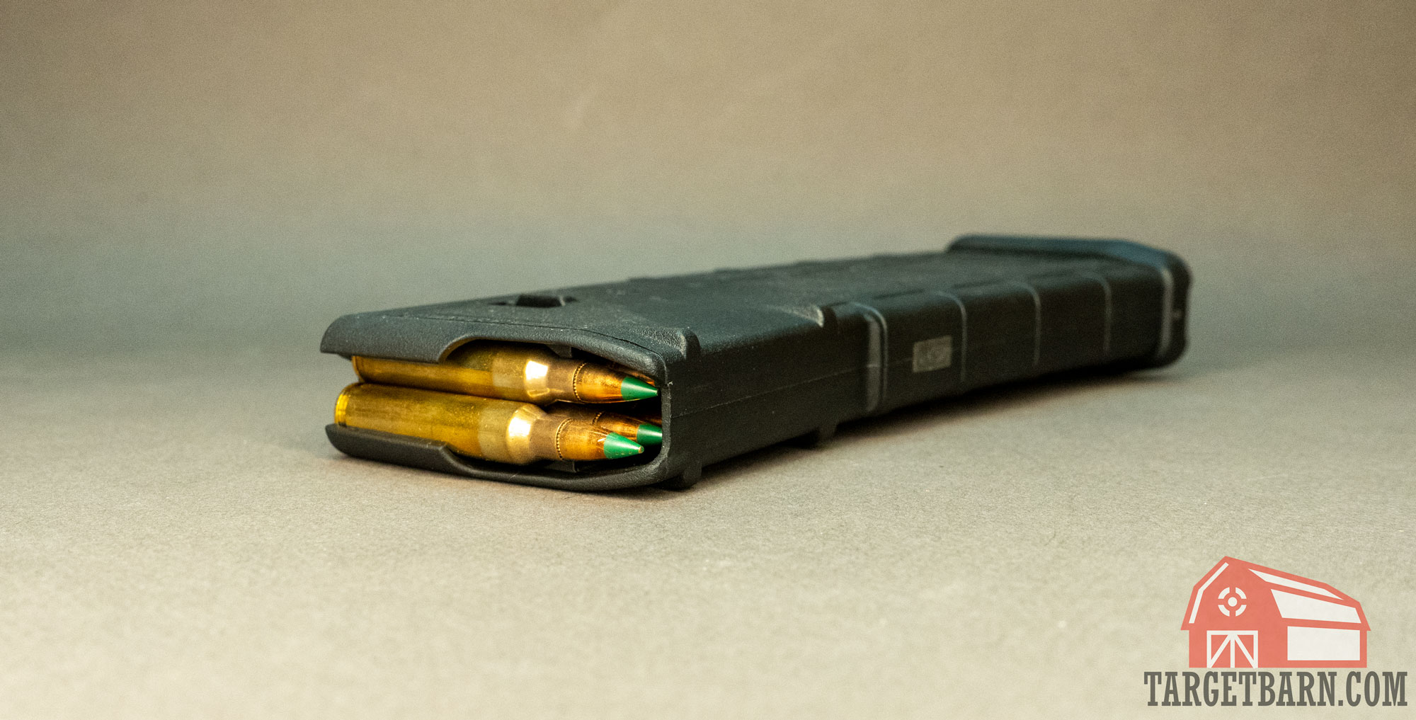 an ar-15 magazine filled with green tip ammo