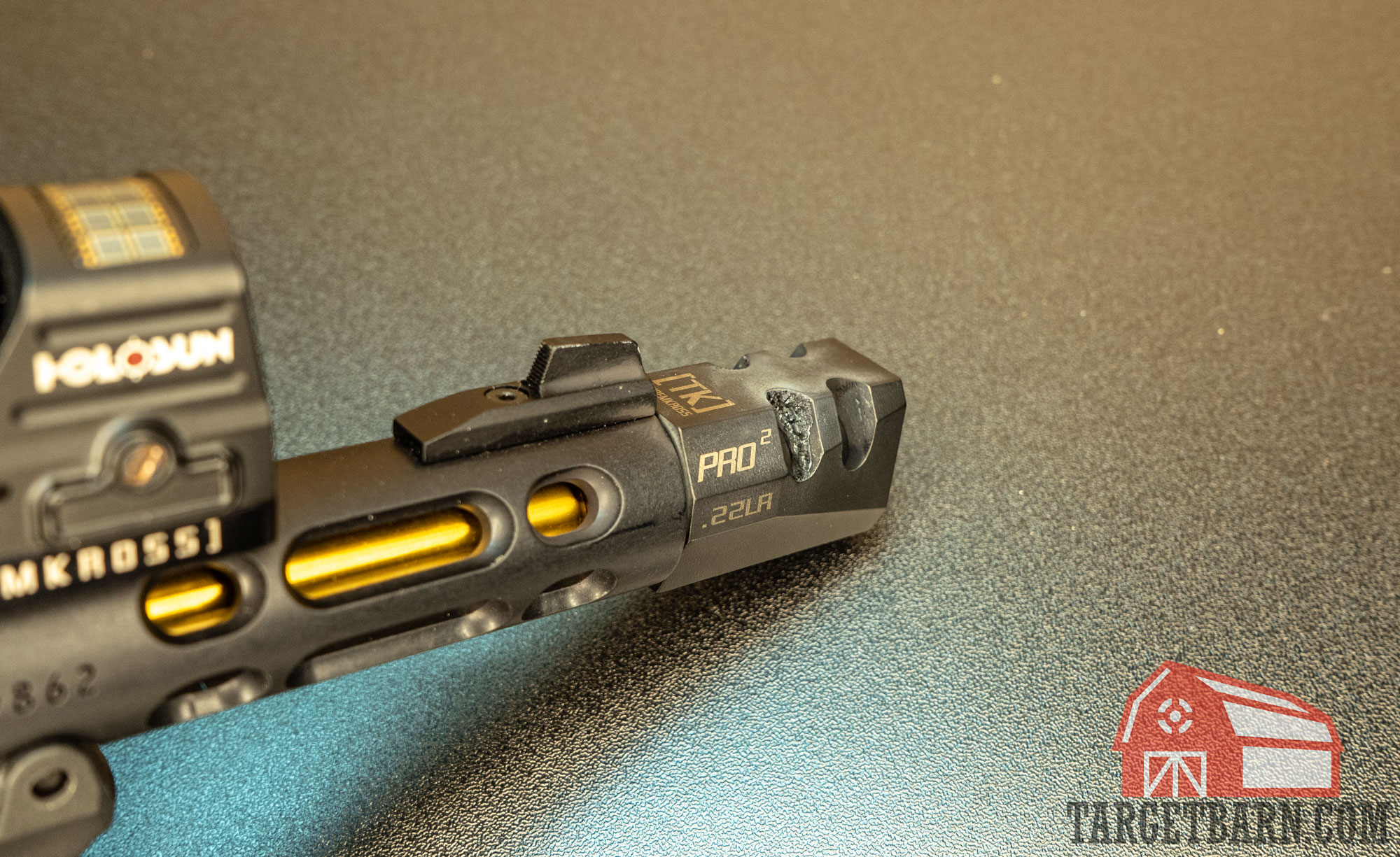 showing the carbon fouling on a pistol compensator and front sight