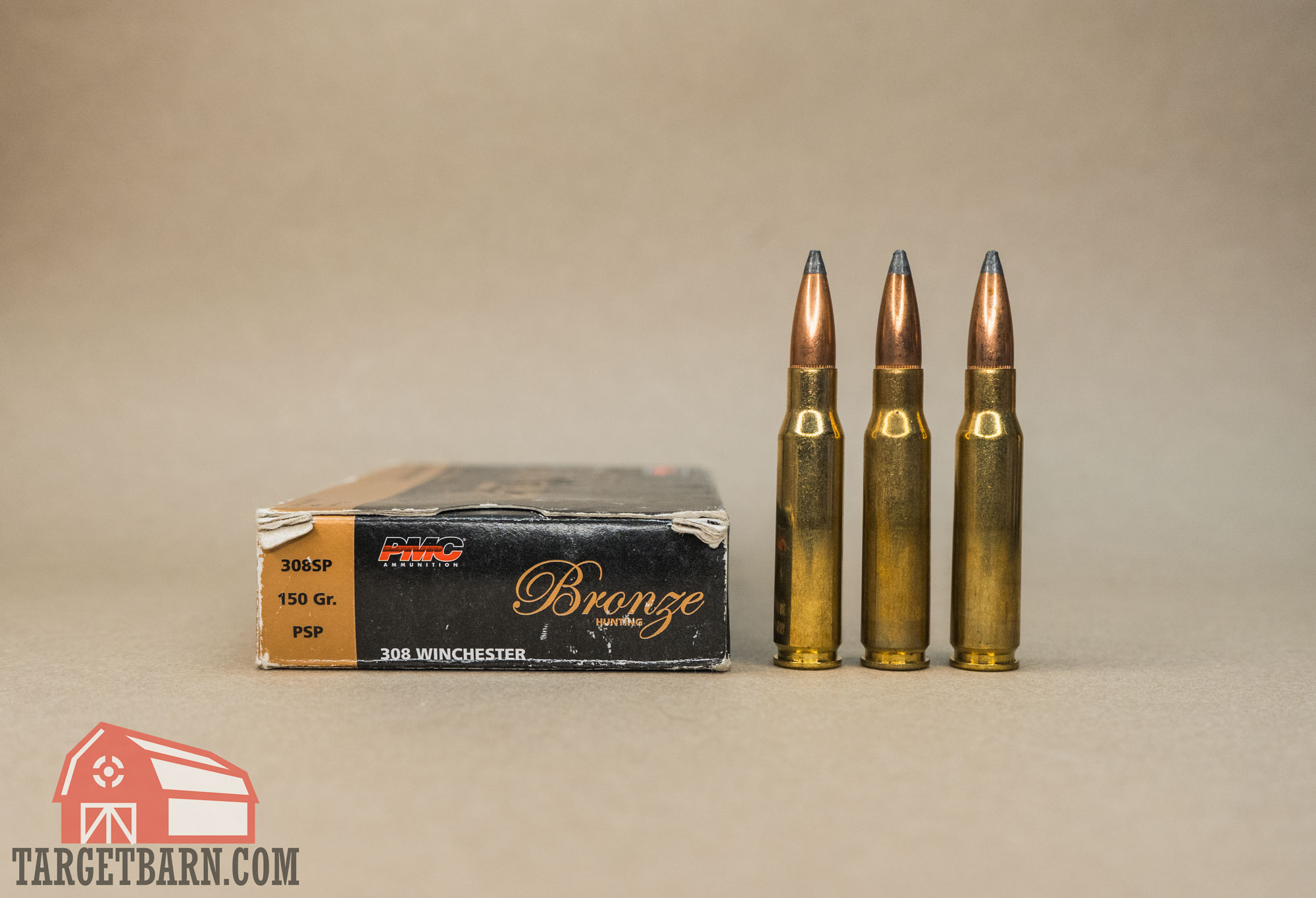 a box and three rounds of pmc bronze 308 ammo