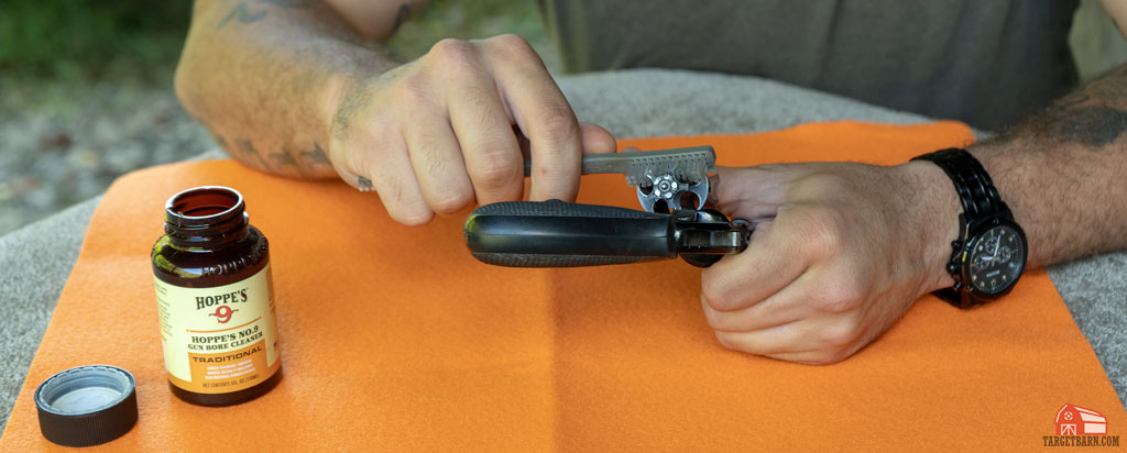 scrubbing under the revolver's extractor star with a nylon brush and gun cleaner