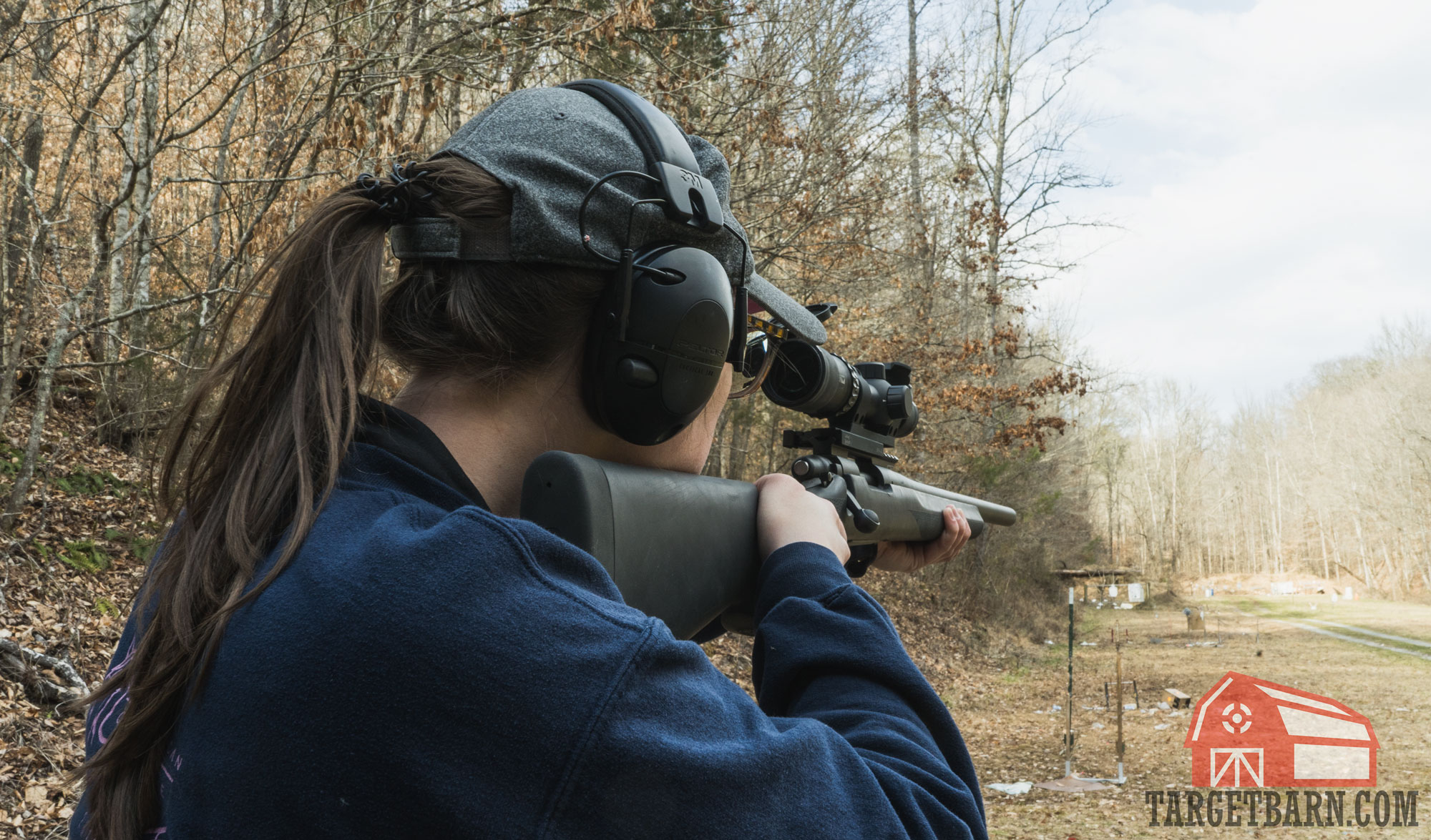 a woman shooting a 308 rifle at the range