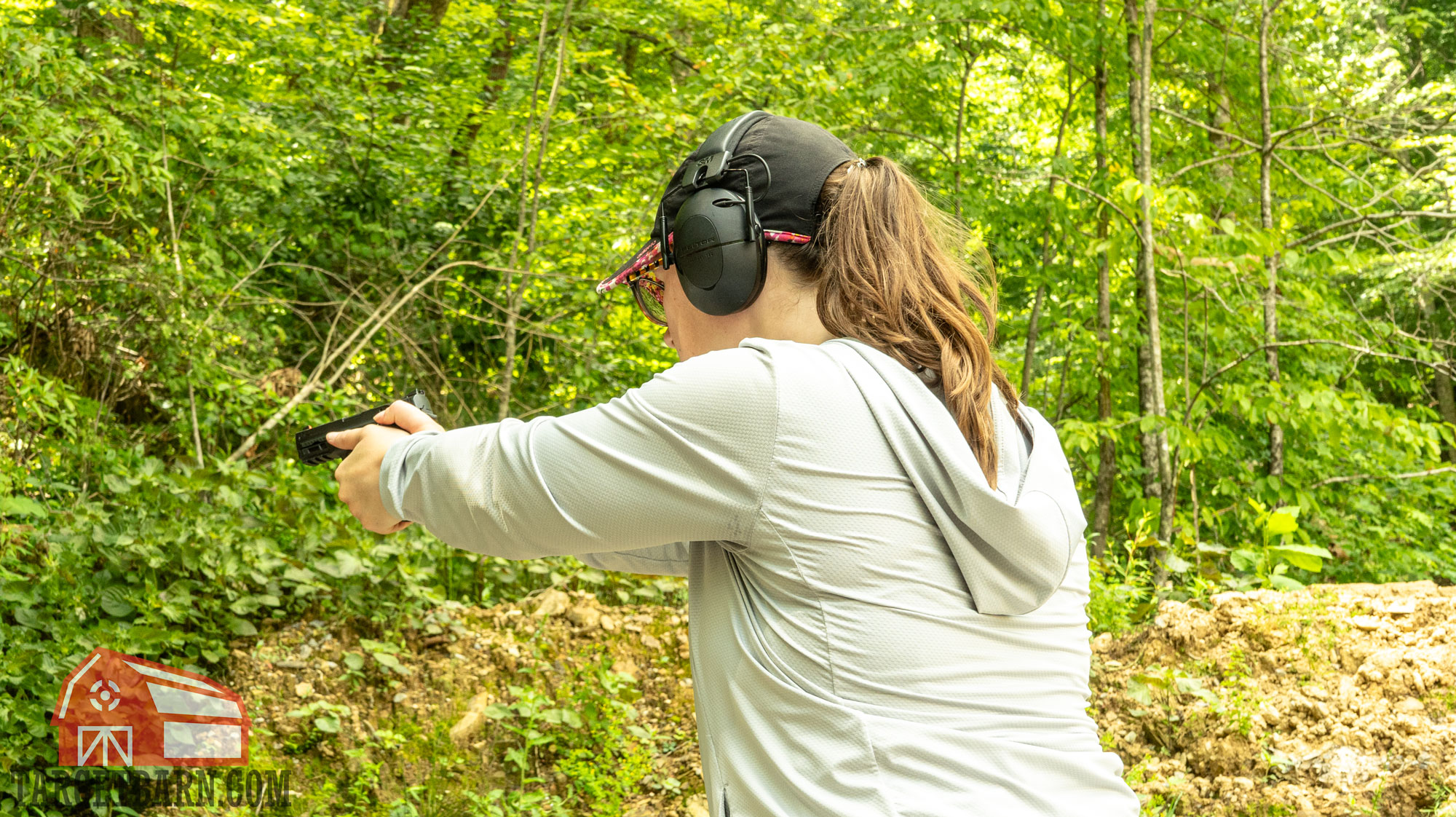 a woman shooting the best .380 ammo at the range