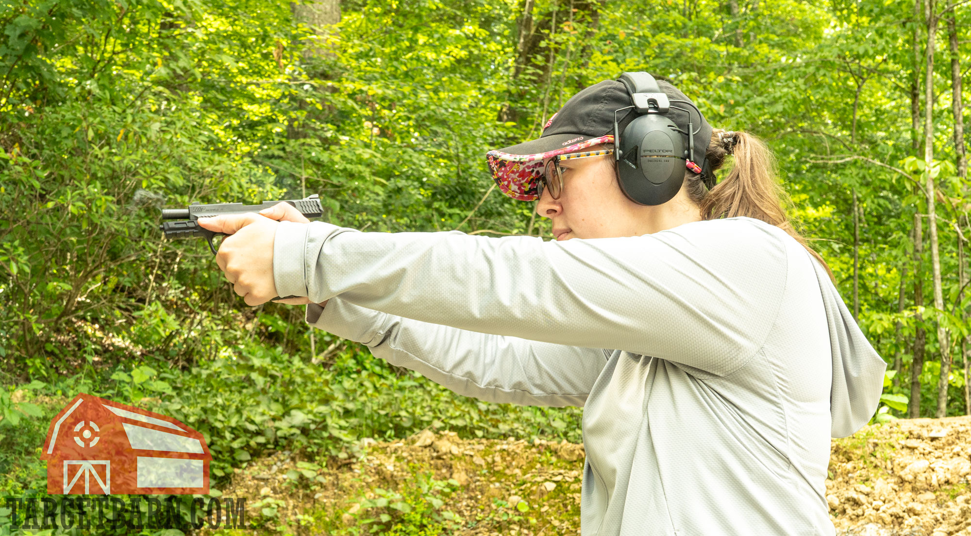 a woman shooting a 9mm pistol 