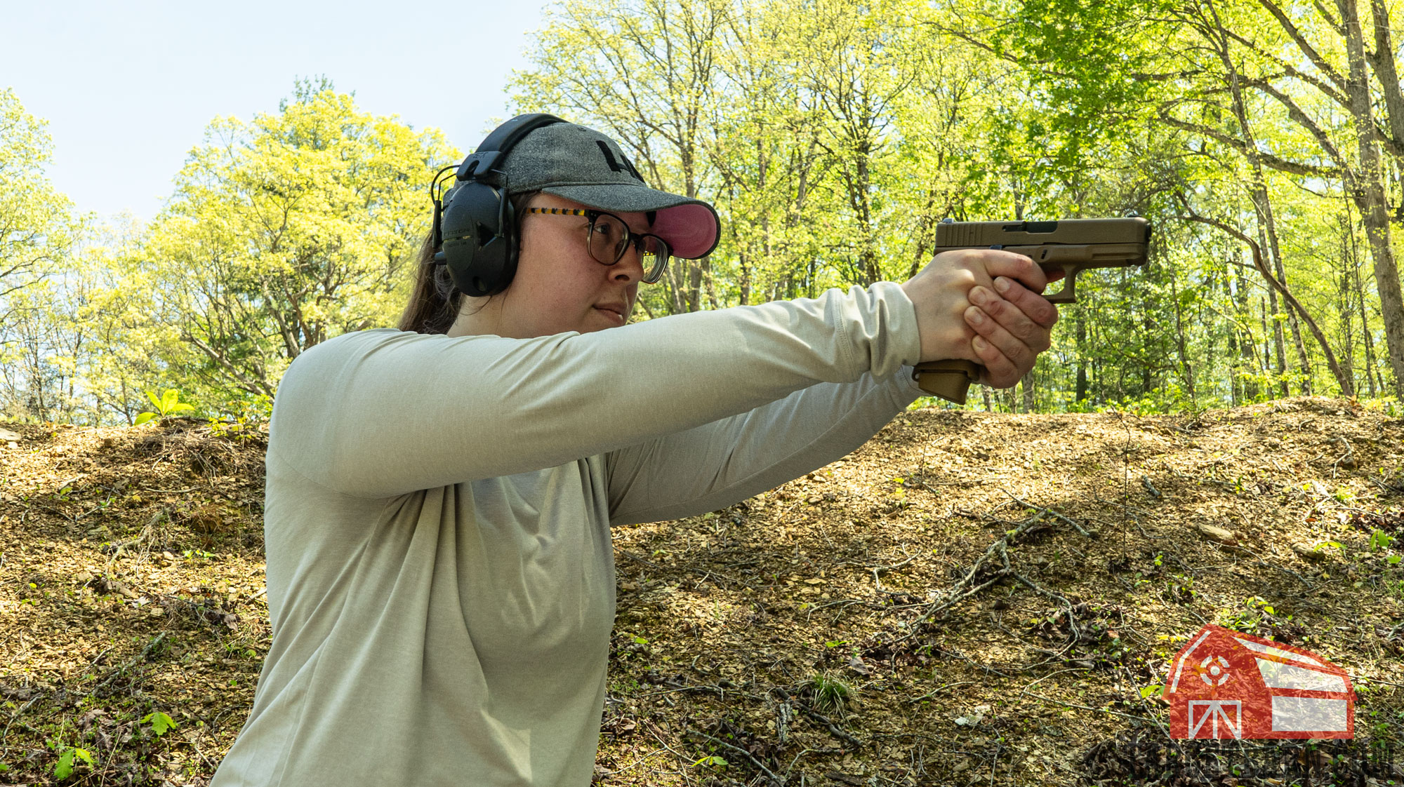 the author shooting a pistol at the range