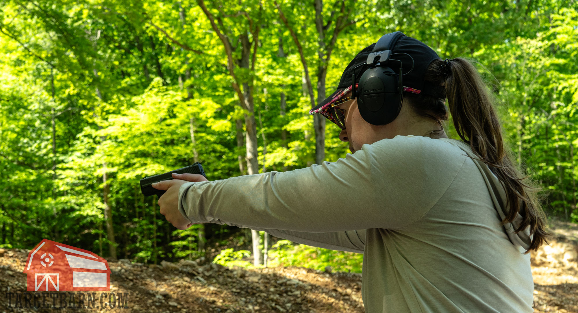 the author shooting a smith & wesson m&p pistol at the range