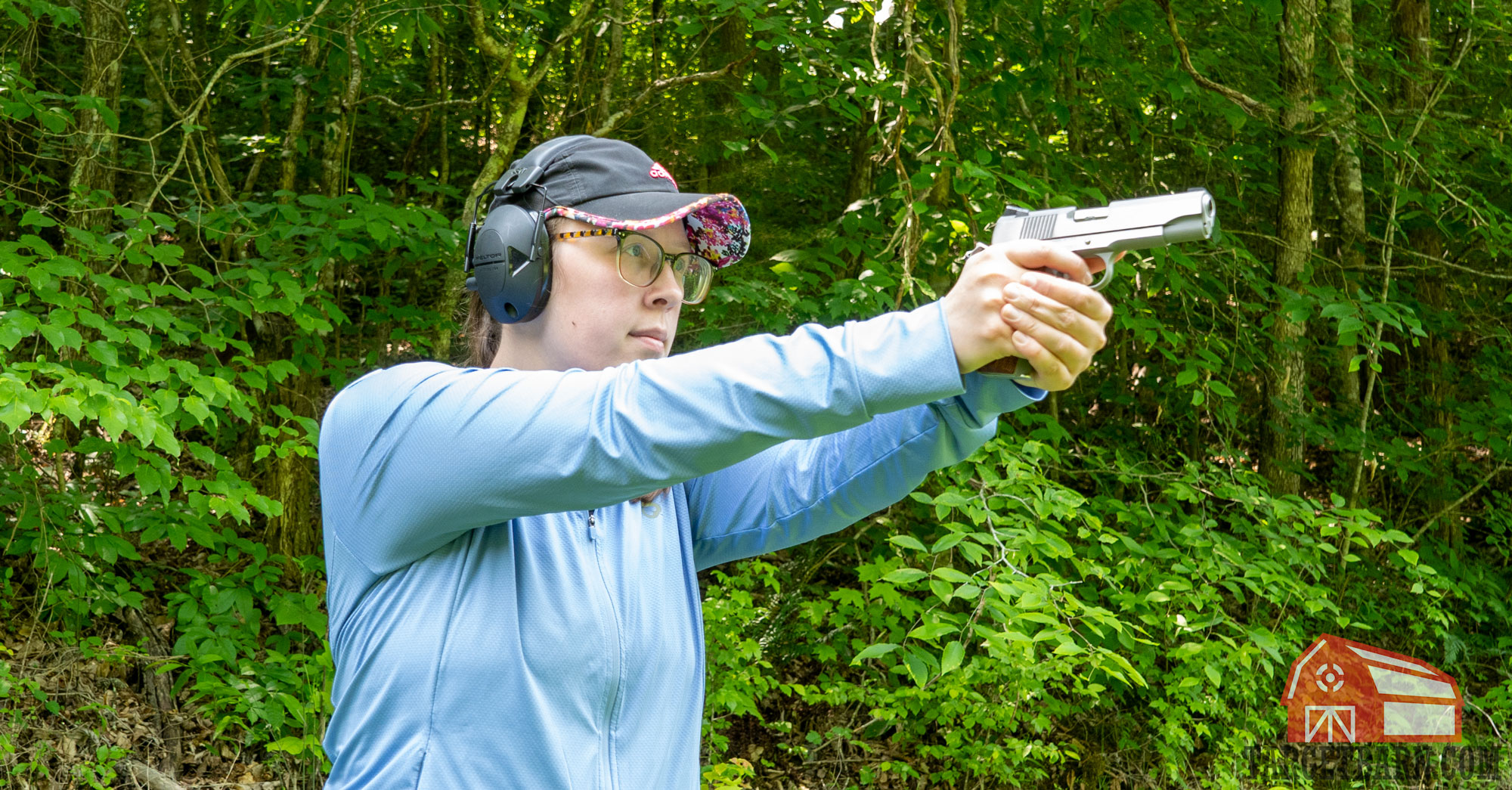 a woman shooting a single-action semi-auto pistol