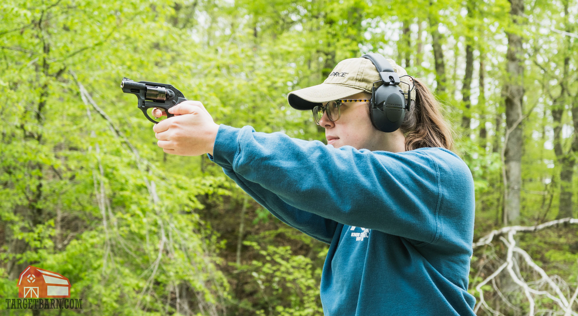 a woman shooting a revolver