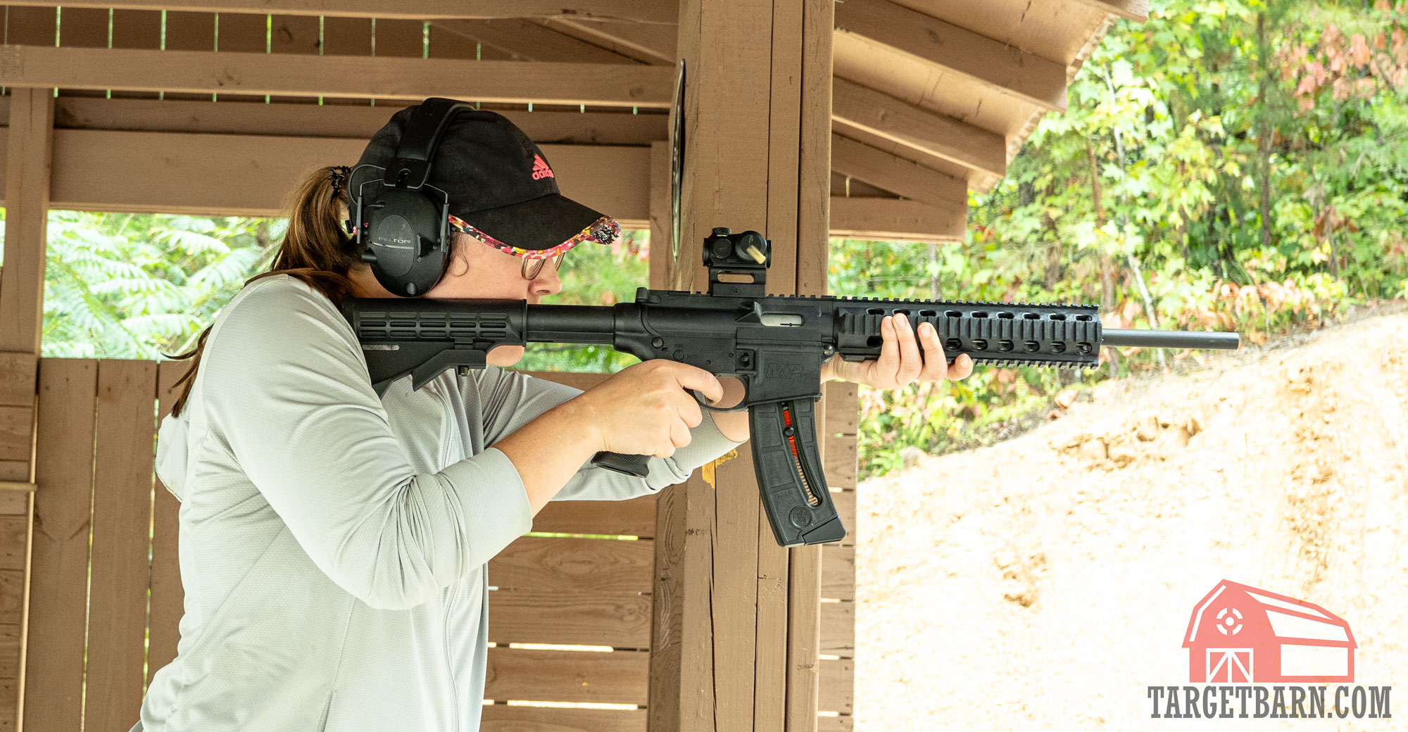 a woman shooting remington thunderbolt out of a smith & wesson m&p15-22 rifle at the range