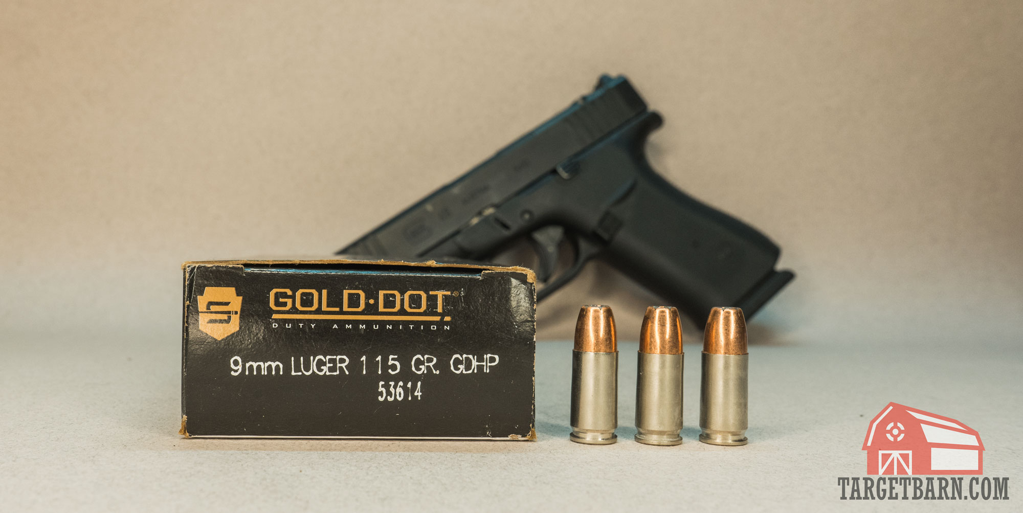 a box and three rounds of speer gold dot 115gr. jhp with a block pistol in the background