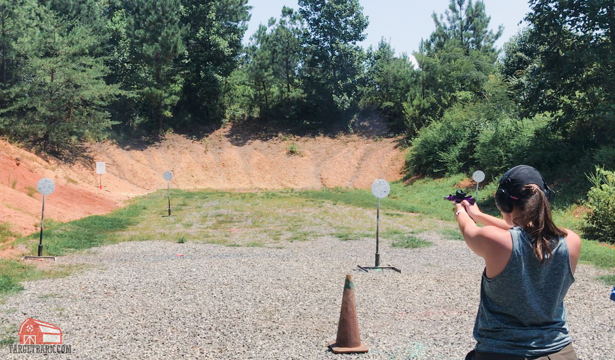 the author shooting her ruger mark iv 22/45 lite at a steel challenge match