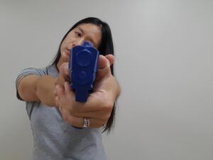 Pistol held with head tilted to one side
