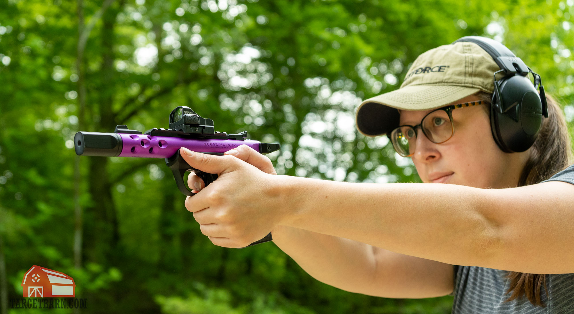 the author shooting a ruger mark 4 with a vortex viper mounted on it